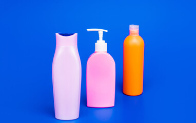 Toiletry and cosmetic plastic containers for liquid shower and bath products packing in row, bottles