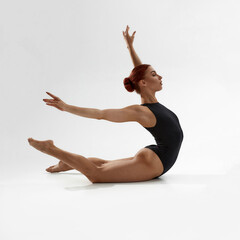 Beautiful woman dancing ballet on white background