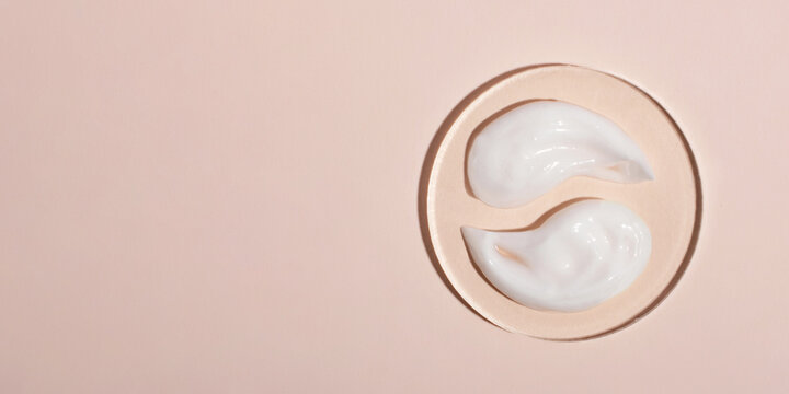 Top view of the cosmetic cream on the acrylic podium,looks like yin yang.Pastel colors,copy space.Good as cosmetics mockup,large banner.