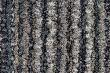 Seamless close up of monochrome grey carpet texture background from above.