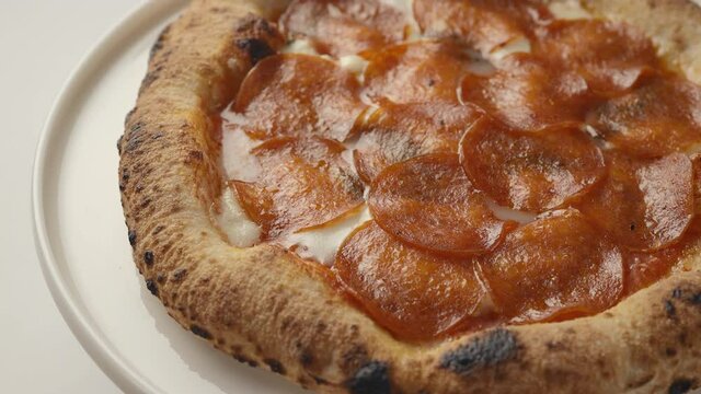 Italian traditional pepperoni pizza spins