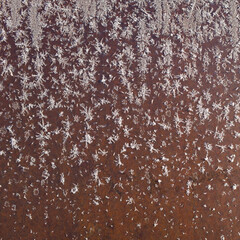 Pattern of ice crystals frost on rusty iron surface, Winter abstract background