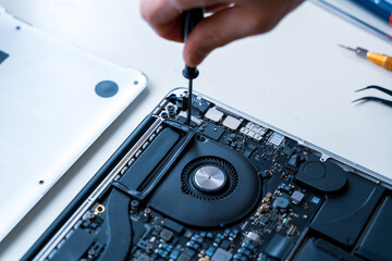 Computer repair man. Pc technician service with laptop on hardware background. Maintenance engineer...