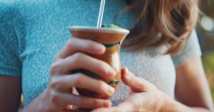 Mate drink. Young woman drinks mate from traditional cup being in the tropical morning garden