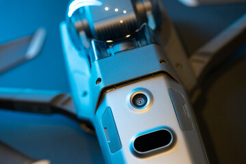 An inverted Mavic 2 Pro quadcopter on a black background in blue light. Infrared sensors and sensor...