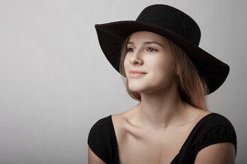 portrait of a girl in a black hat. beautiful face close-up	
