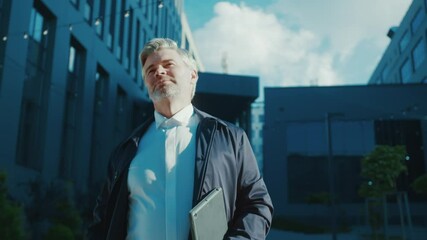 Professional lawyer handsome mature bearded man wearing business suit walking in contemporary street outdoors. Businessman. Boss. Lifestyle. People and employment.