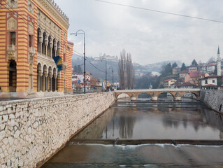 Sarajevo City Hall and the old stone bridge on the Miljacka River in Sarajevo