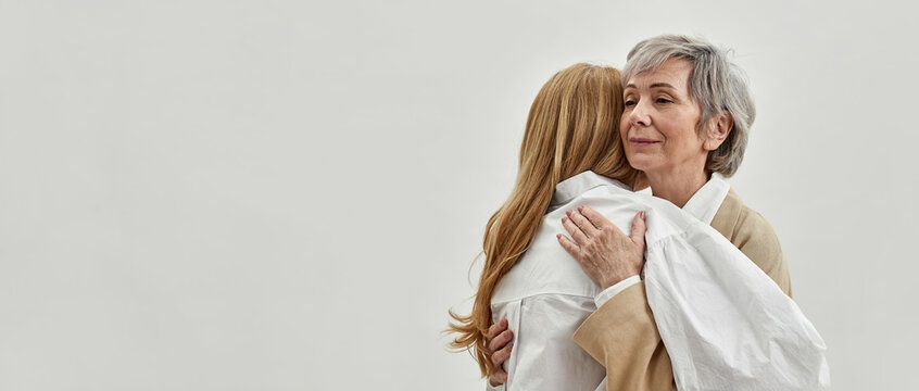 Loving old mother hug support grownup daughter
