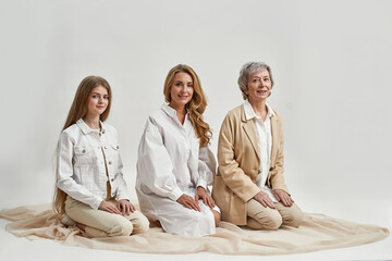Portrait of three generations of women on studio background