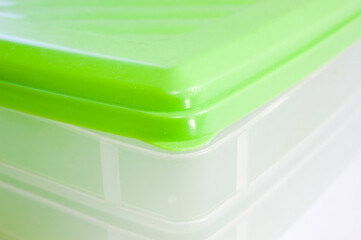 Plastic box with green lid and transparent box