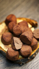 Selective focus. Macro. Chocolate truffles on a wooden surface.