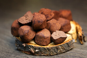 Selective focus. Macro. Chocolate truffles on a wooden surface.