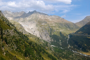 Naklejka premium The furka pass road with the remnants of the Rhône glacier and the young Rhône river flows in the valley