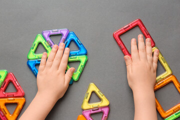 Child is playing with multi-colored blocks