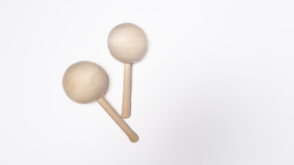 Wooden baby rattles on a white background
