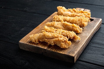 Chicken breaded wingshell on black wooden table