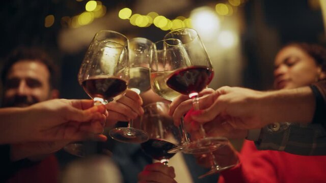 Close Up Footage of People Making Toasts and Touch with Wine and Champagne Glasses at a Garden Party Celebration with Friends on a Warm Summer Evening. Beautiful People Enjoy Life on a Weekend.