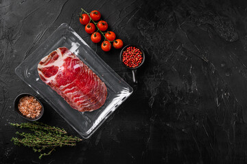 Italian meat cold cuts pack, on black dark stone table background, top view flat lay, with copy space for text