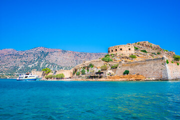 Obraz premium View of the island of Spinalonga with calm sea. Here were isolated lepers, humans with the Hansen's desease, gulf of Elounda, Crete, Greece. 