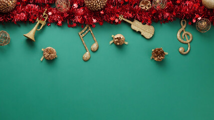 Christmas composition. Top view golden Christmas musical instruments decoration on green background...