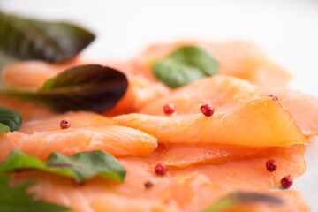 Slices of smoked salmon on white background
