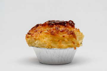 Coconut candy. Traditional Brazilian dessert, also known as queijadinha, on a white background.