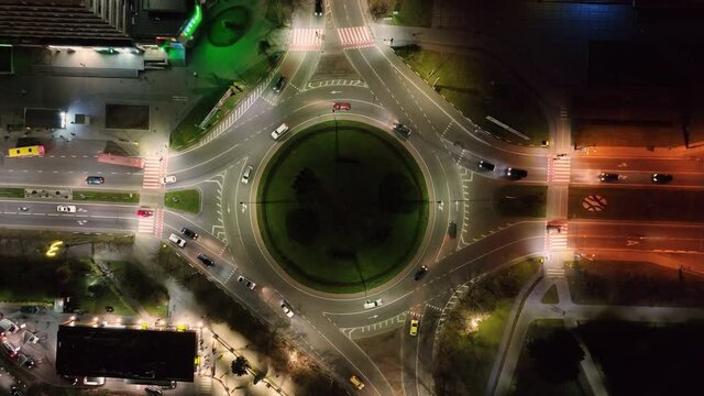 Aerial Top view of car traffic at roundabout lane. Drone aerial zoom out. Urban cityscape concept or abstract of advanced innovation, financial technology, energy power