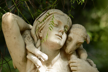 sculpture of a woman with a sheep or goat in her arms, in the botanical garden of buenos aires in a...