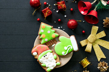 
New Year's composition. Christmas tree decorations balls on a wooden background. Glazed gingerbread. Flat lay, top view, copy space

