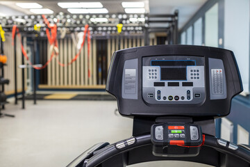 treadmill controls in foreground, background blurred