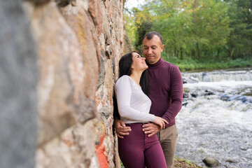 beautiful young couple posing near the river
