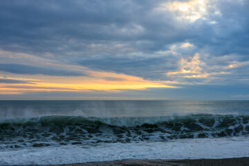 evening landscape at regime time on the sea coast, severe tragic clouds, after the rain