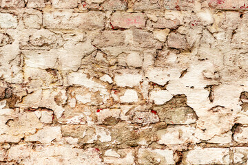 Texture of a brick wall with cracks and scratches which can be used as a background