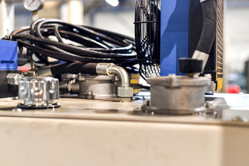 Hoses connected to the hydraulic oil station in the workshop.