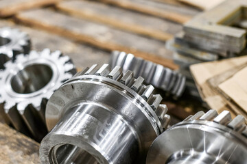 Several spur gears, after CNC processing, lie on the beams, close-up.