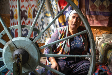 Uzbekistan, in the city of Margilan, a woman makes silk threads in the traditional way. 5th of...