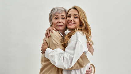 Portrait of smiling adult daughter and mature mom - obrazy, fototapety, plakaty