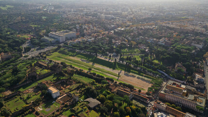 Aerial drone photo of iconic Circus Maximus a green space and remains of a stone - marble arena used for chariot races built next to Palatine hill and world famous Colosseum, historic Rome, Italy