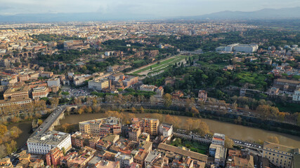 Fototapeta premium Aerial drone photo of iconic Circus Maximus a green space and remains of a stone - marble arena used for chariot races built next to Palatine hill and world famous Colosseum, historic Rome, Italy
