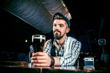 Barman makes a cocktail in the taproom