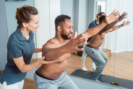 Young black man receiving physical therapy on his shoulder