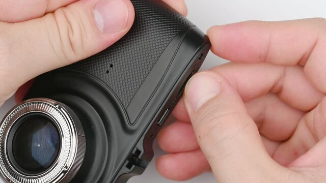 camcorder dashboard security car camera or dashcam with hand holding isolated on white background.
