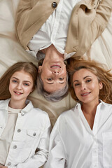 Narrow top view of smiling three women generations