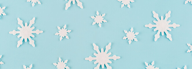 Christmas composition. Banner made of snowflakes on blue background. Christmas, winter, new year concept. Minimal style. Flat lay, top view