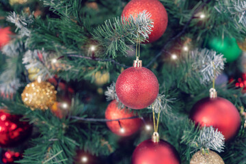 Closeup of red bauble hanging from Christmas tree. New Year concept
