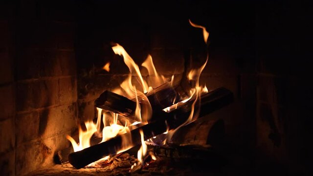 Burning Fire In The Fireplace. Wood And Embers In The Fireplace Detailed fire background. A looping clip of a fireplace with medium size flames