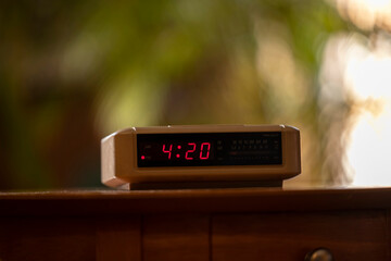 Detail of vintage digital alarm clock sitting on side table