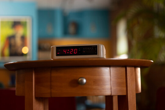 Detail of vintage digital alarm clock sitting on side table