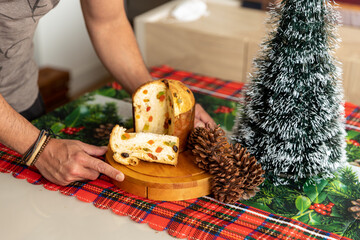 man serving delicious slice of panettone on christmas day